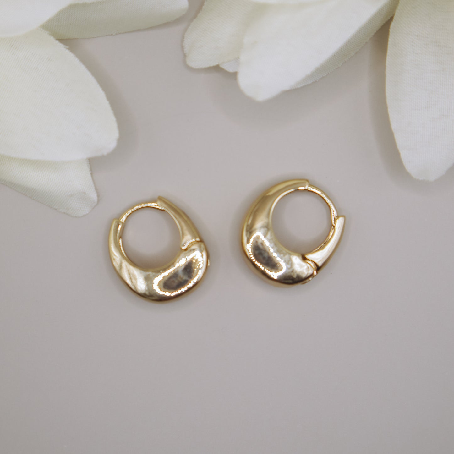 Chunky gold huggies earrings for women, K-pop inspired.