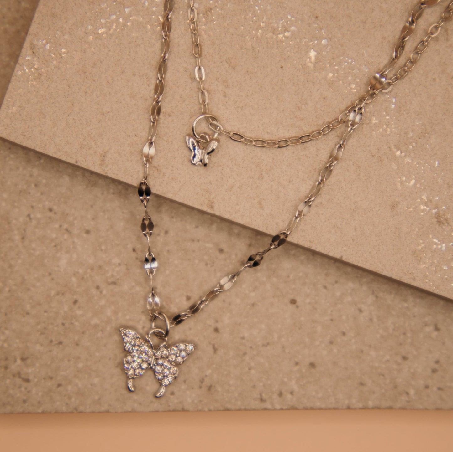 Layered butterfly pendant necklace, gold and silver