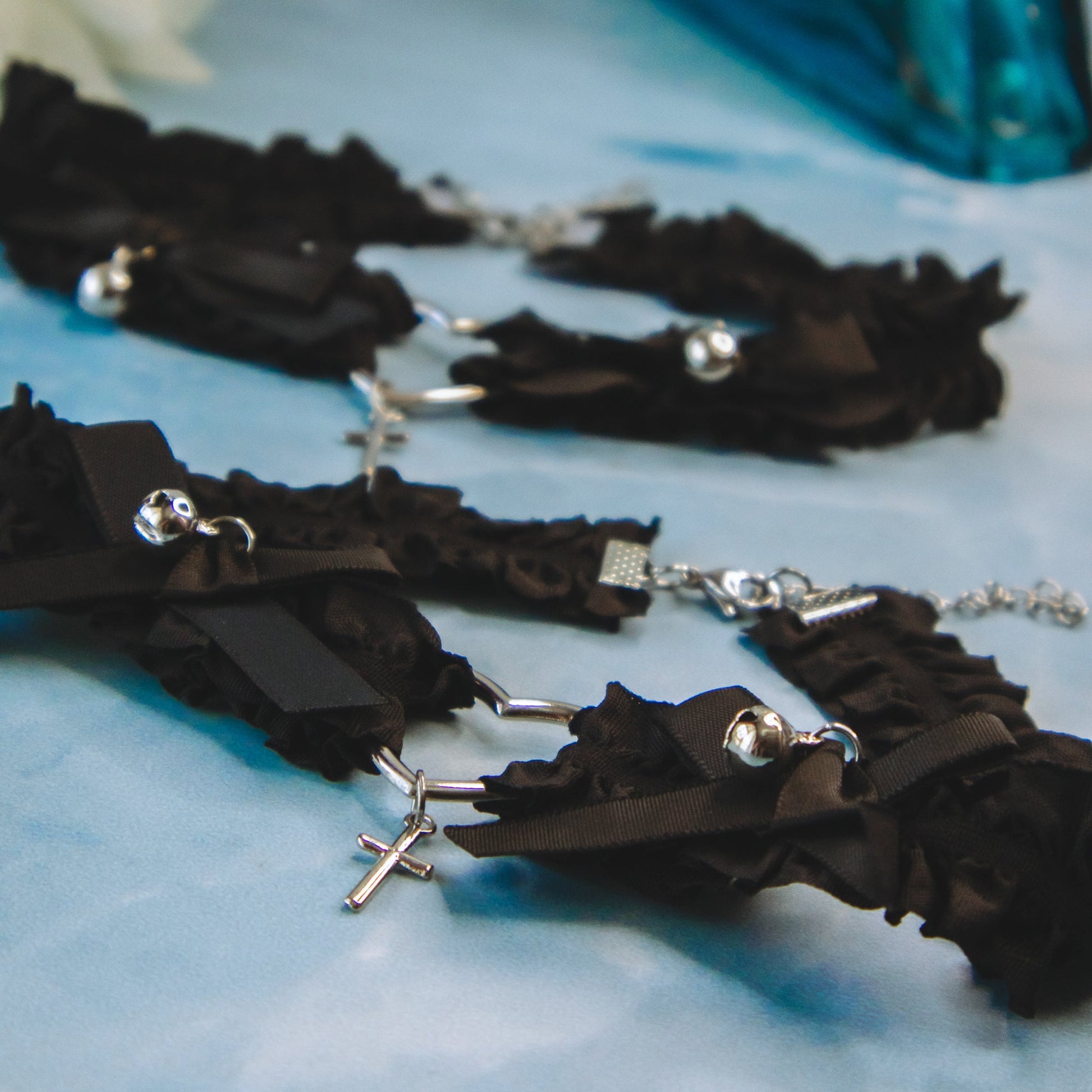 black ribbon choker with bell and silver heart details