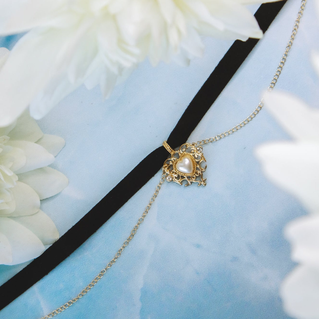 choker necklace with gold detail on blue surface