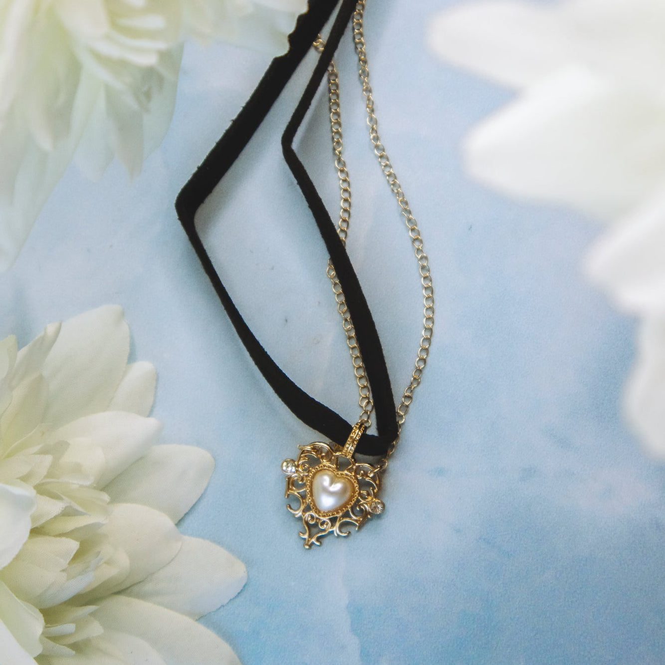 choker necklace with gold detail on blue surface