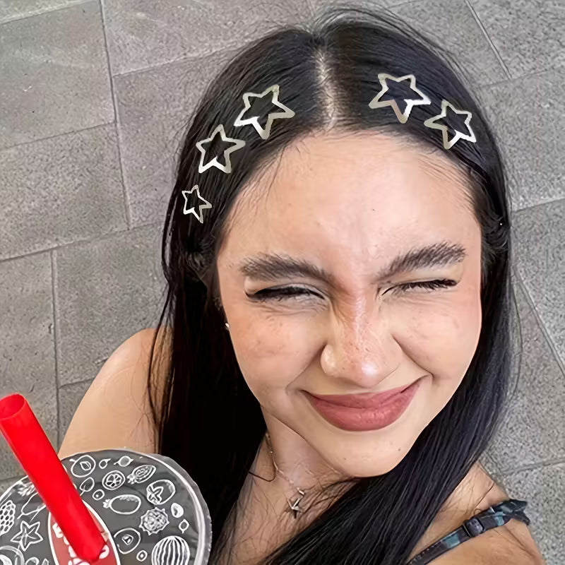 Woman with star-shaped hair clips on a gray pavement background